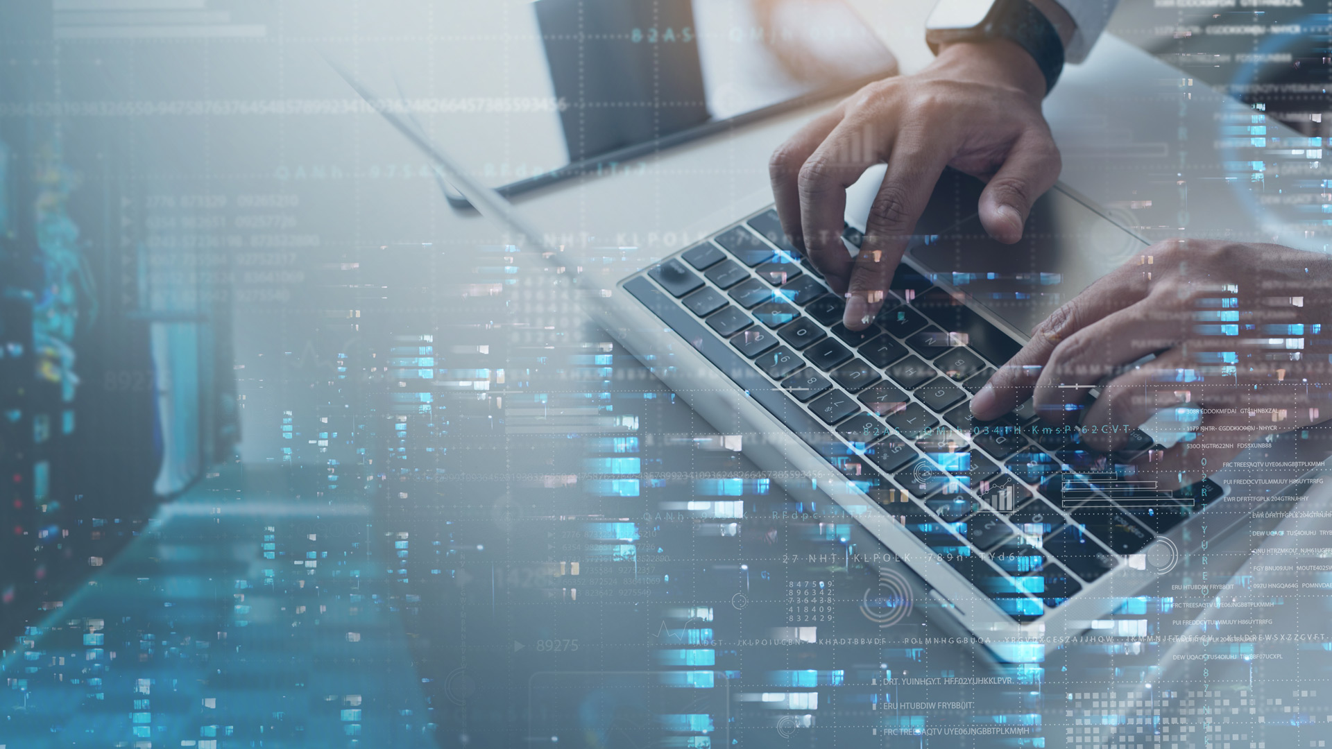 Man writing on a laptop keyboard with server infrastructure overlaying the picture