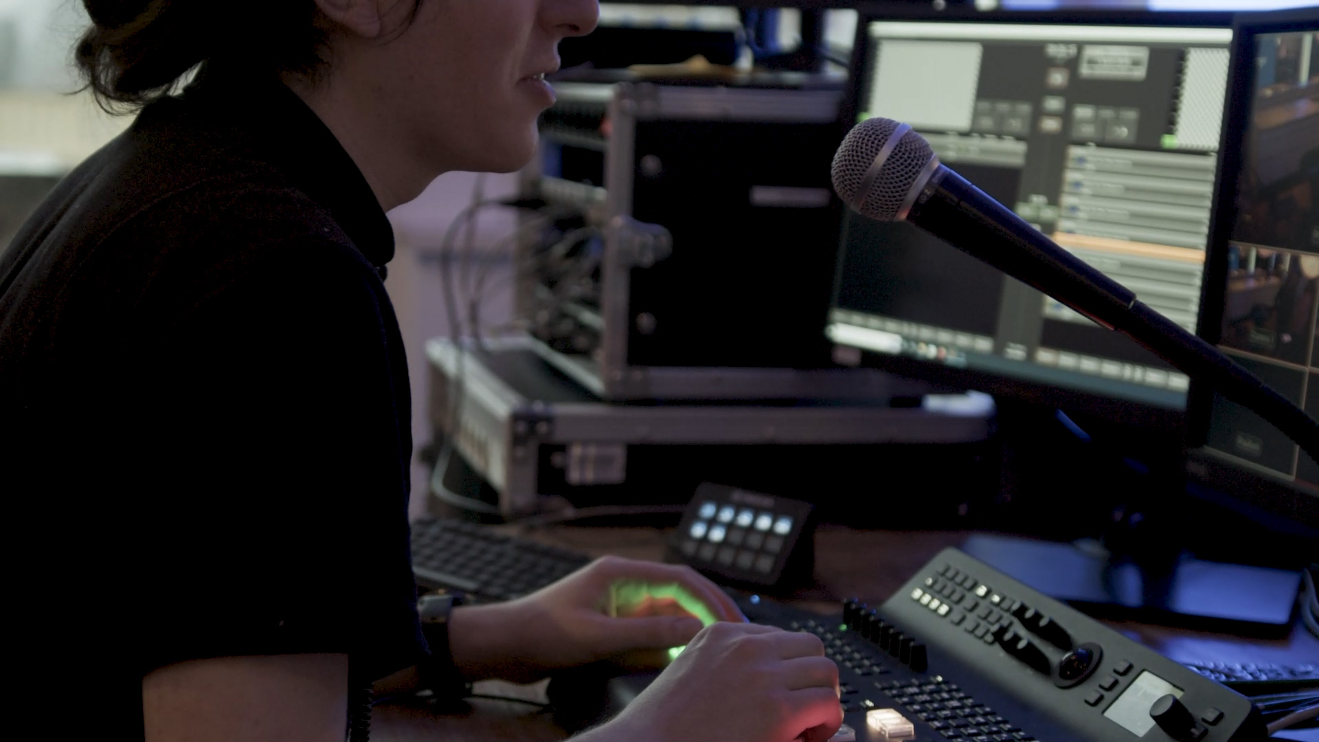 A worker talking into a micropho ne during a livestreaming production