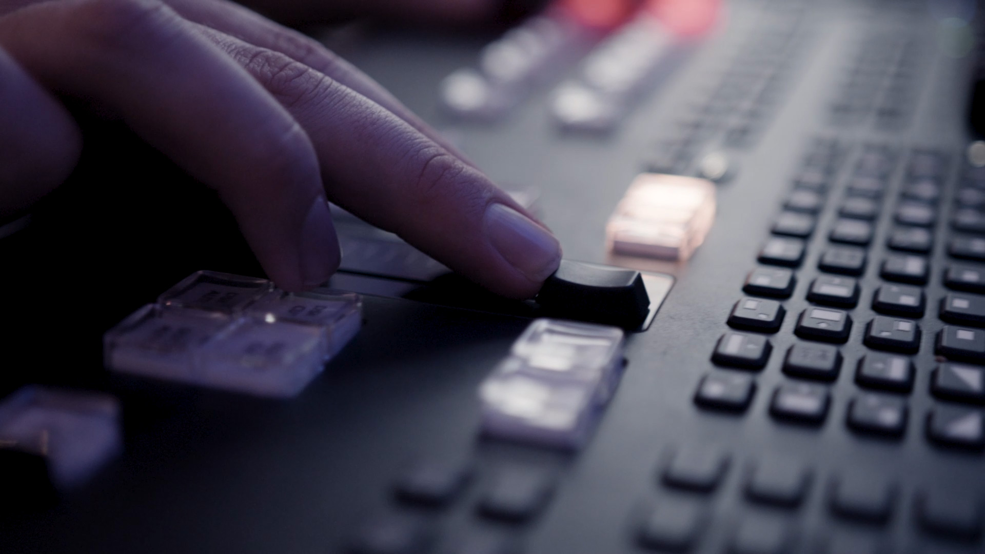 A closeup shot of a hand adjusting equipment during a livestreaming production